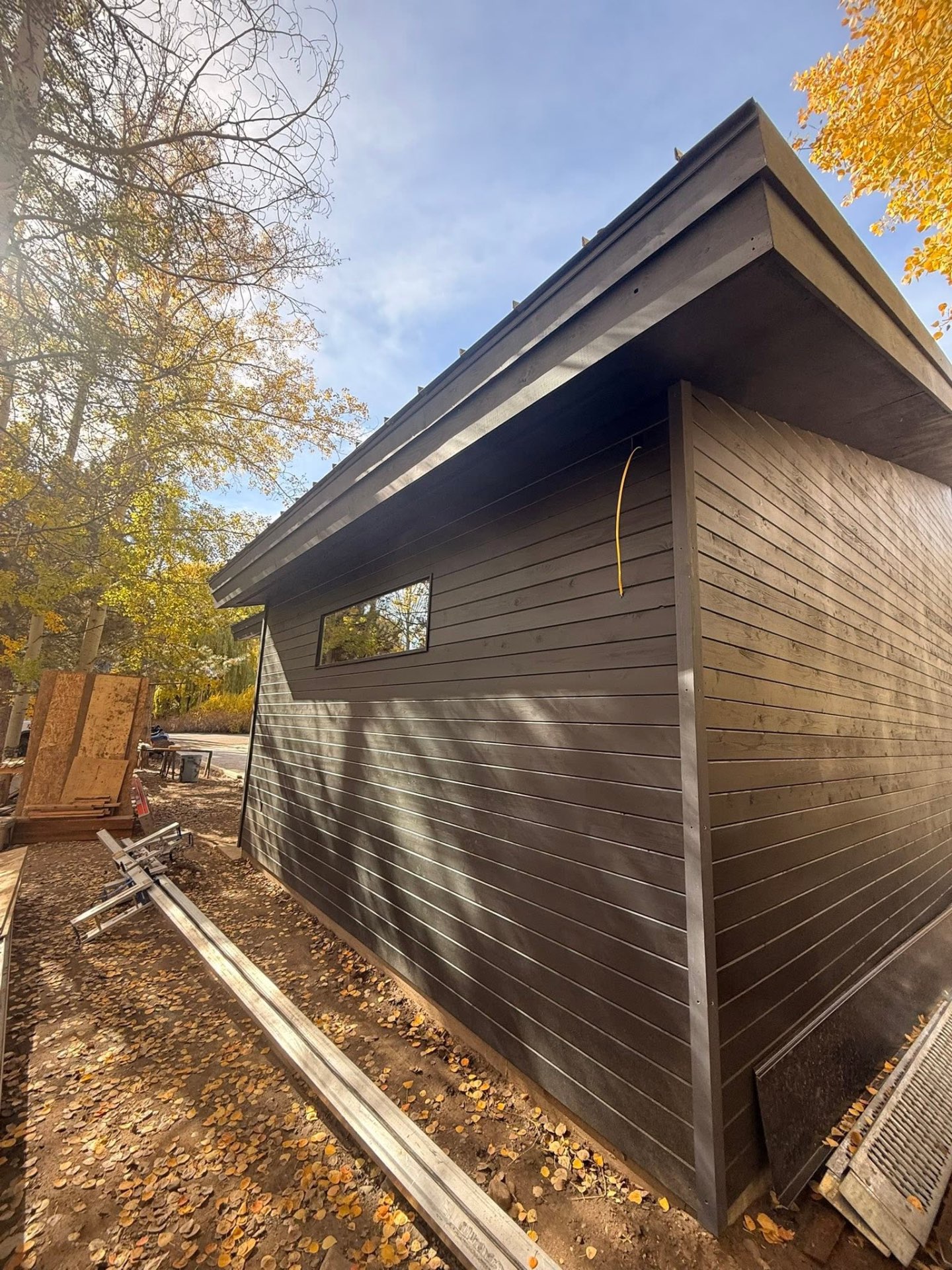 Dark stained horizontal wood siding on modern exterior
