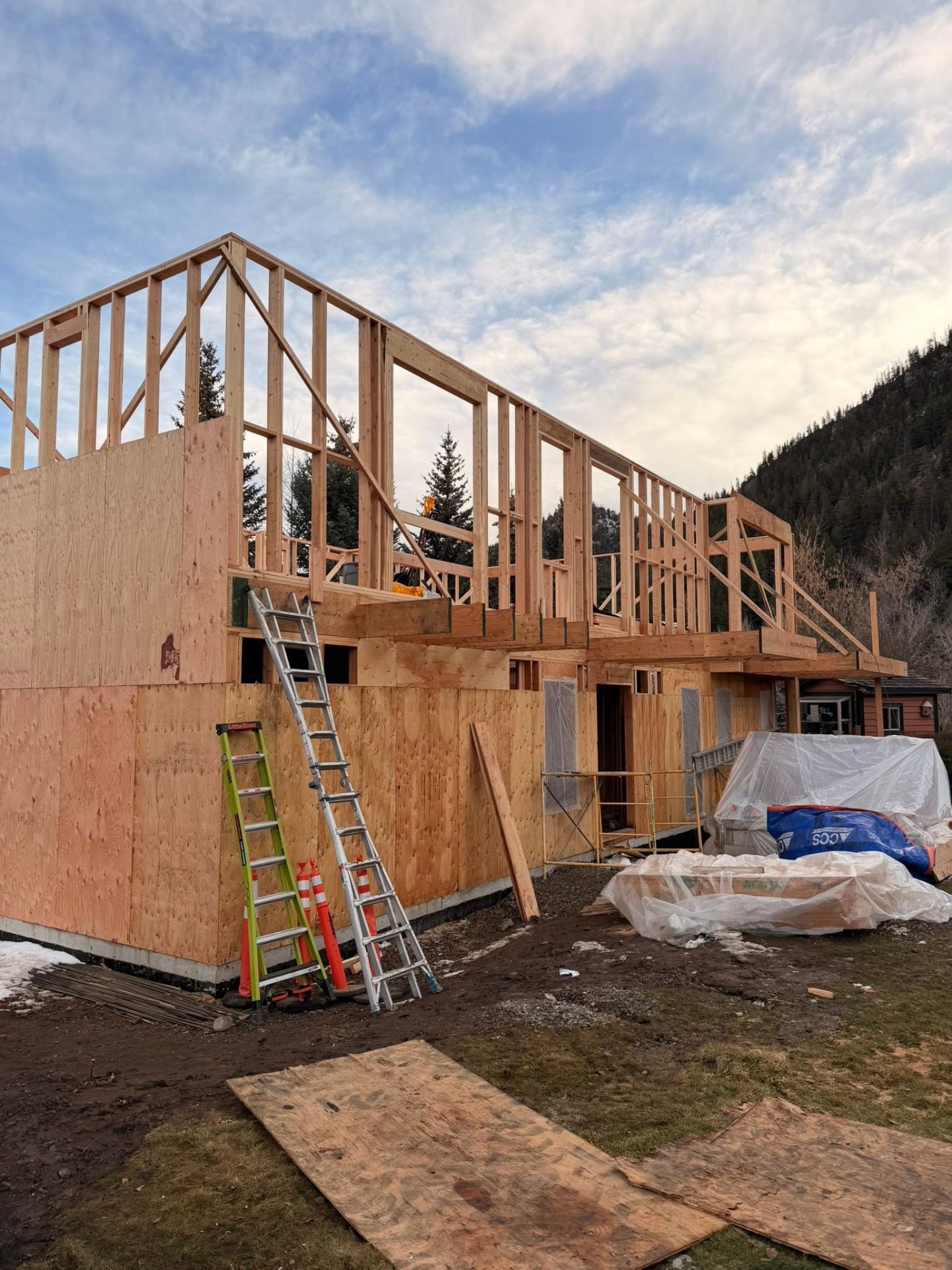 Two-story custom home framing at sunset